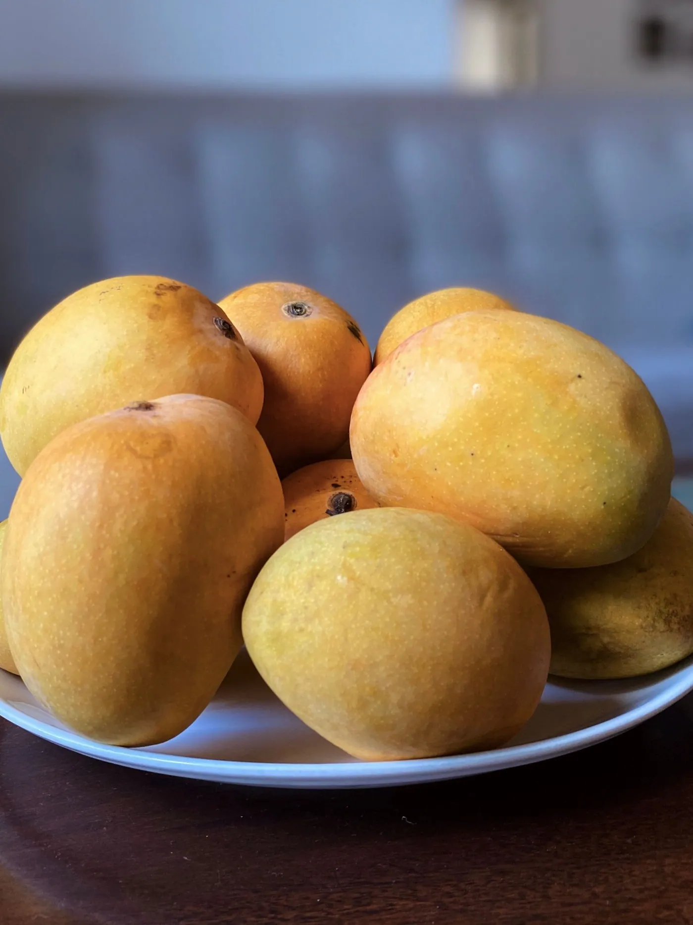 Ripe mangoes heaped on a plate